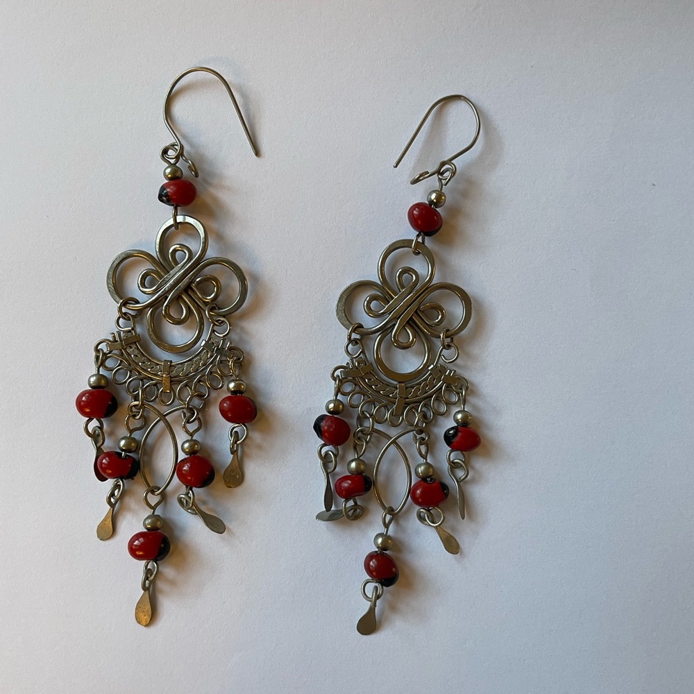 Pair of silver earrings with red beads and hook closure